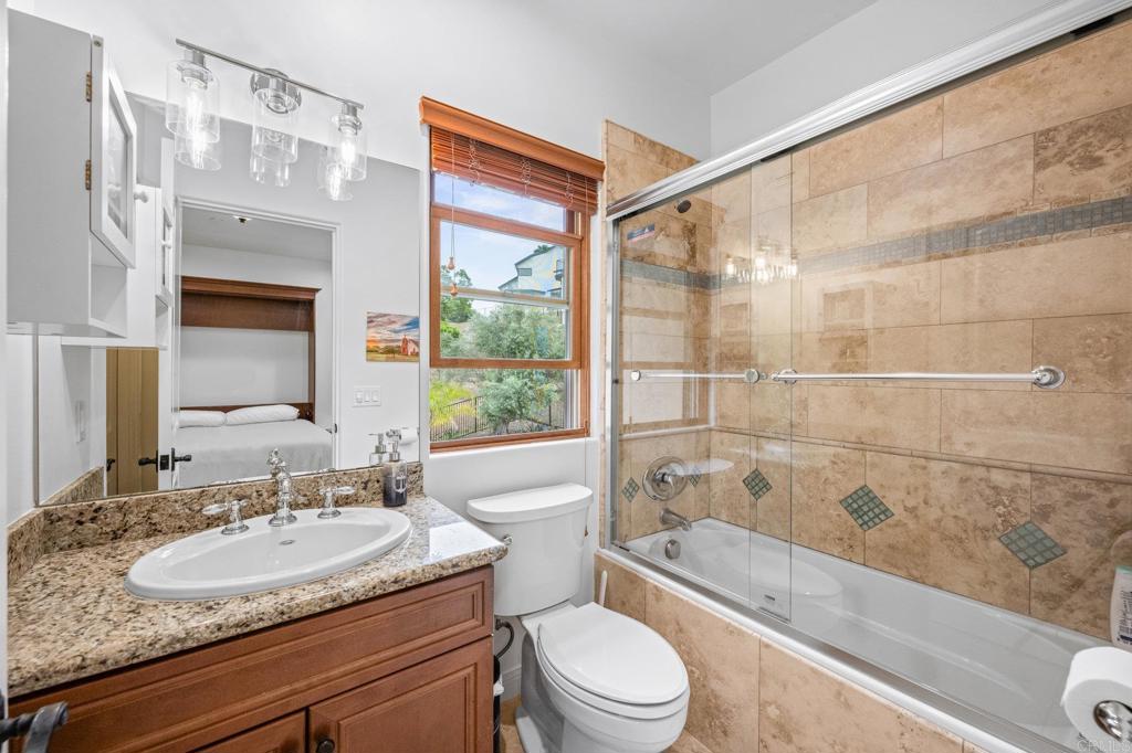 4149 Manchester Avenue Encinitas, CA 92024 - Photo 34 of 60 a bathroom with a granite countertop sink toilet and shower