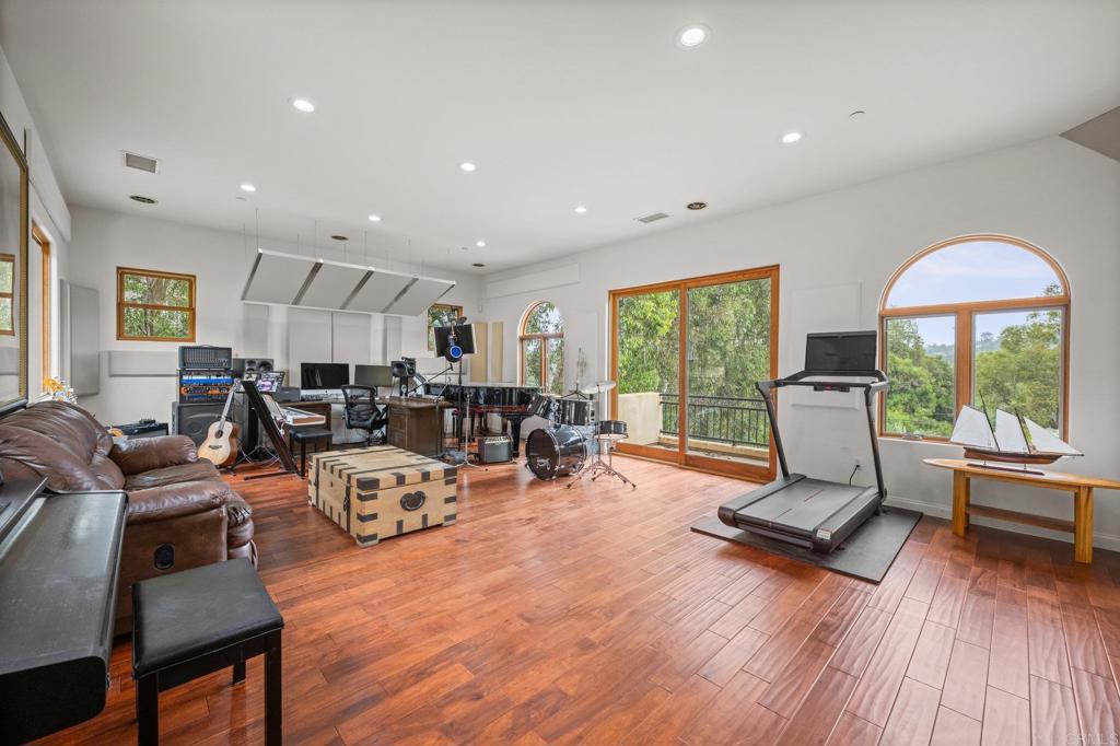 4149 Manchester Avenue Encinitas, CA 92024 - Photo 41 of 60 a living room with furniture hard wood floor and a floor to ceiling window
