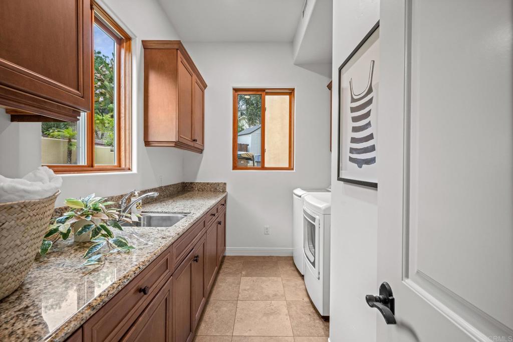 4149 Manchester Avenue Encinitas, CA 92024 - Photo 42 of 60 a bathroom with a granite countertop sink and a washing machine