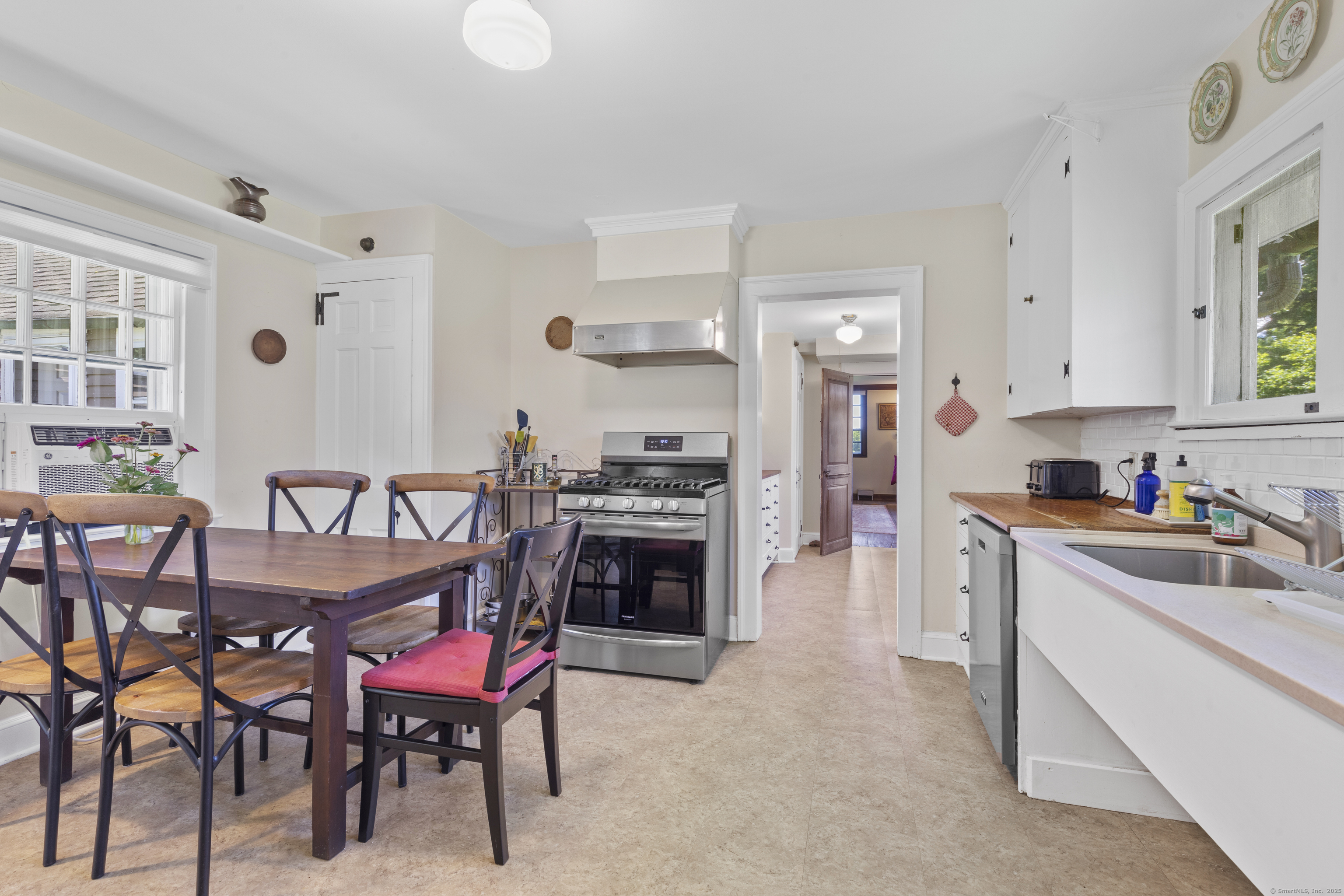90 Duck Hole Road Guilford, CT 06437 - Photo 11 of 38 a kitchen with granite countertop a table chairs stove and cabinets