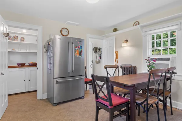 a view of a dining room with furniture and a window
