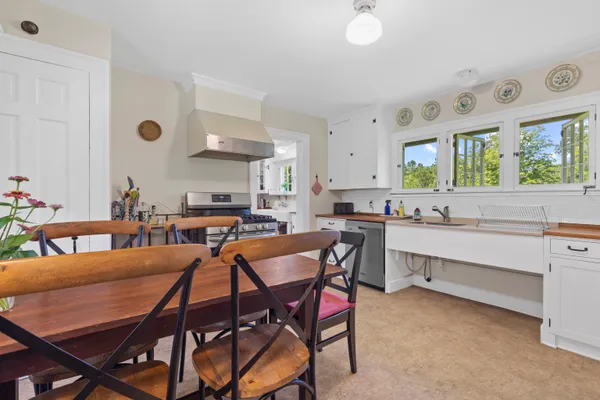 a view of a dining room with furniture and window