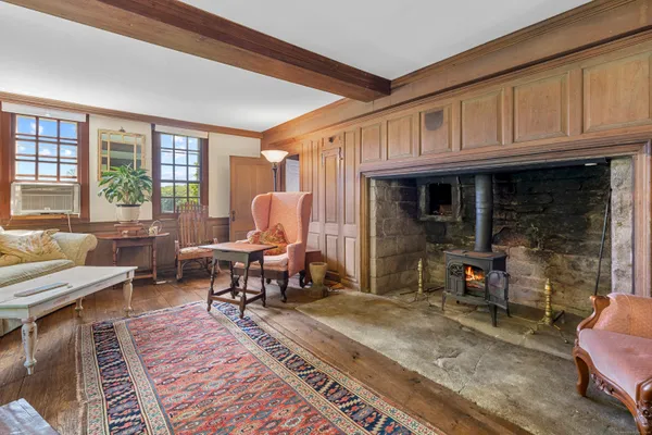a living room with furniture a rug and a window
