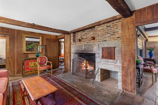 a living room with furniture a fireplace and a table