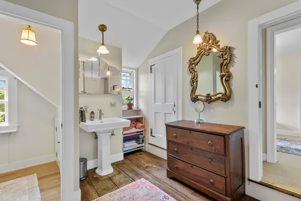 a bathroom with a sink a mirror and a shower