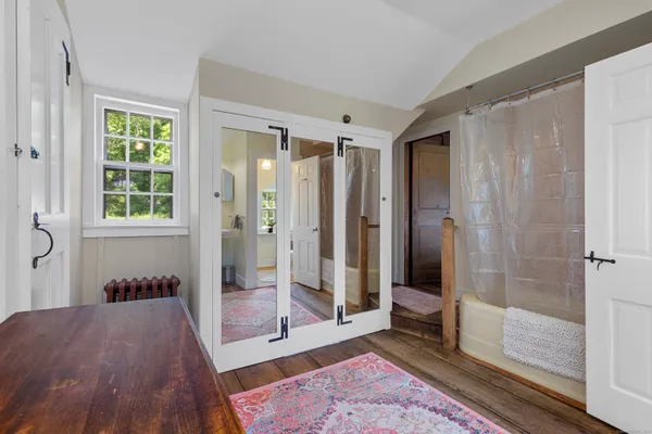 a view of a bathroom with a tub shower and mirror