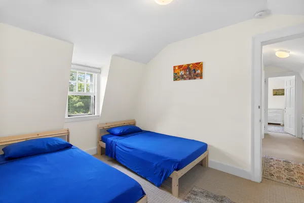 a bedroom with two beds and a window