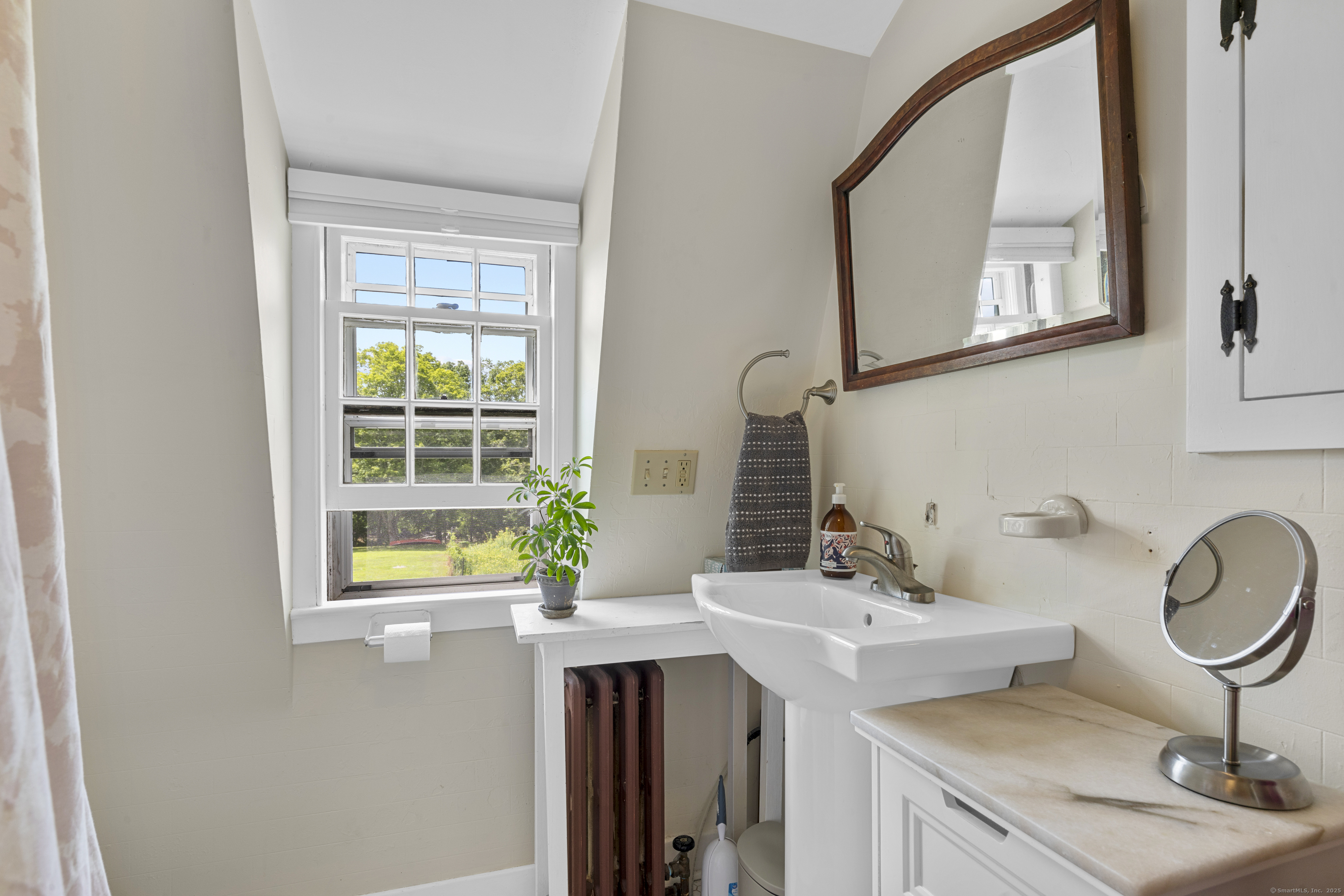 90 Duck Hole Road Guilford, CT 06437 - Photo 34 of 38 a bathroom with a sink and a mirror