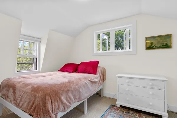 a bedroom with a bed and window