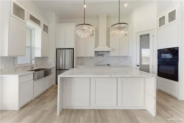 a kitchen with stainless steel appliances a counter top space and cabinets