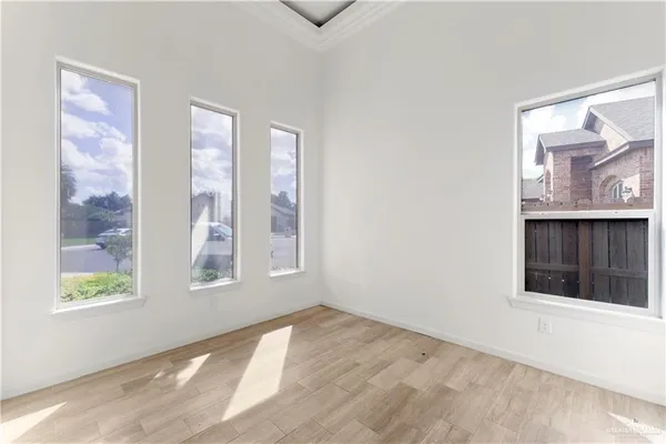 a view of an empty room with window and closet area