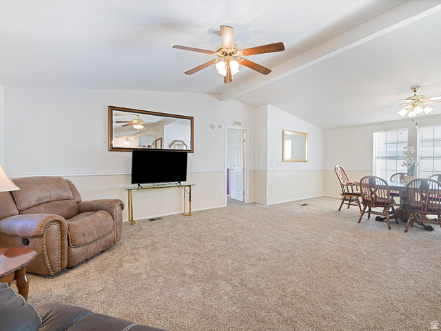 3941 West 40 North Hurricane, UT 84737 - Photo 11 of 55 Open-concept living space featuring vaulted ceilings, ceiling fans with light fixtures, and neutral carpeting