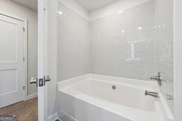 a white bath tub sitting next to a white sink