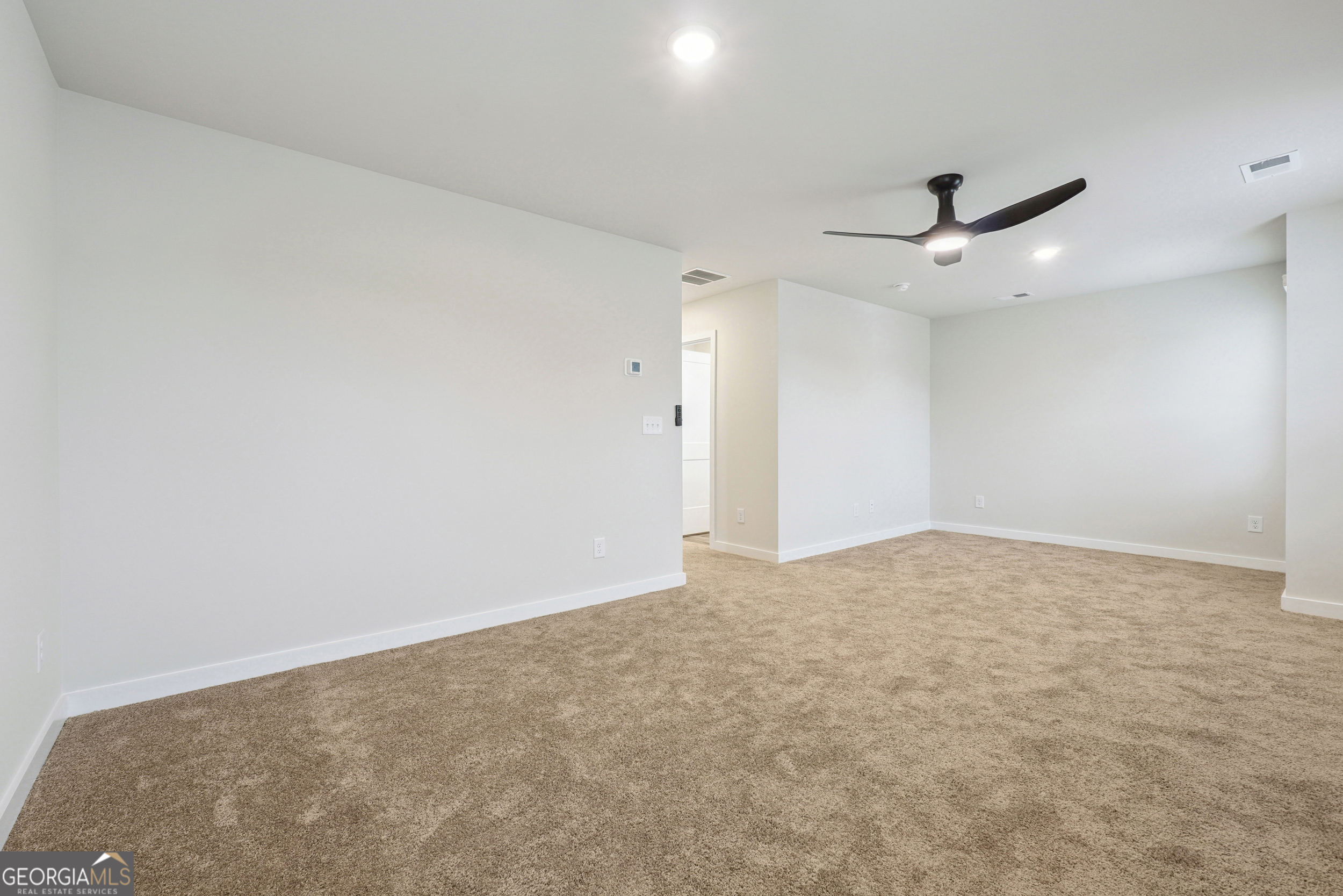 201 Harris Walk, Unit 20 West Point, GA 31833 - Photo 19 of 25 an empty room with a empty space and a ceiling fan