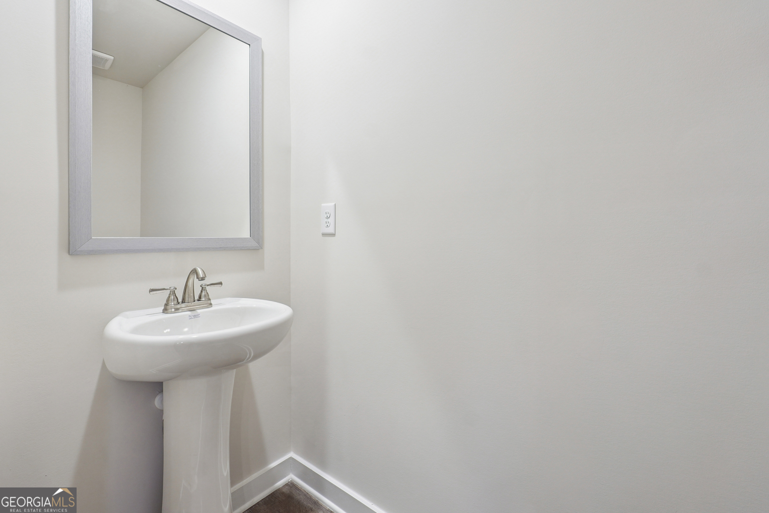 201 Harris Walk, Unit 20 West Point, GA 31833 - Photo 23 of 25 a bathroom with a sink a mirror and a a window