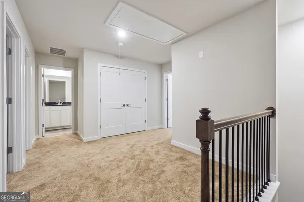 a view of hallway with wooden floor