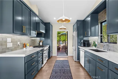 a view of a patio with couches under an umbrella