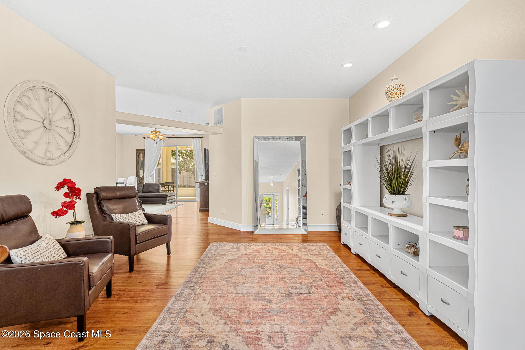 3751 Manitoba Way Rockledge, FL 32955 - Photo 26 of 64 a living room with furniture and a book shelf
