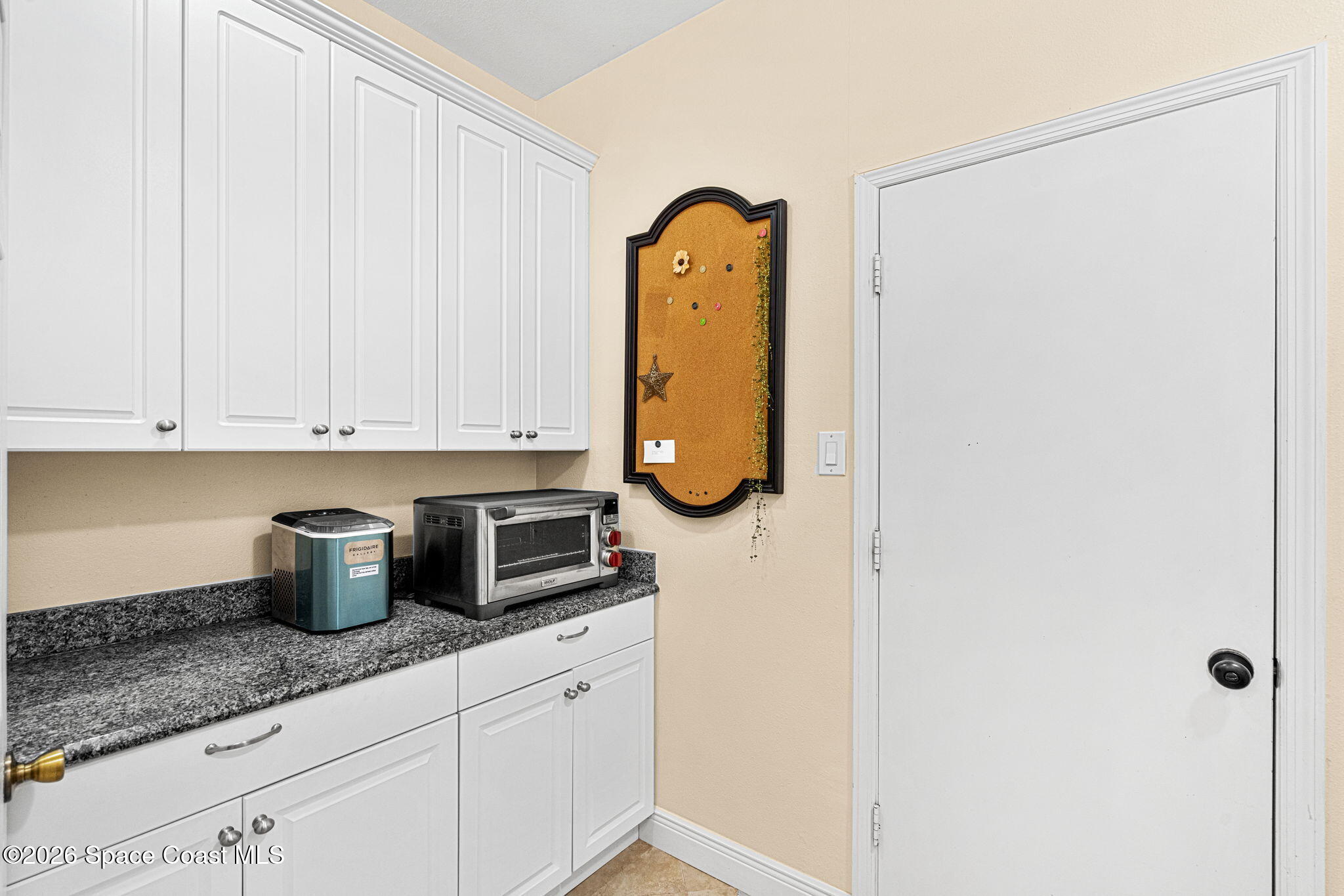 3751 Manitoba Way Rockledge, FL 32955 - Photo 40 of 64 a kitchen with stainless steel appliances granite countertop a sink a granite counter tops and a view of living room