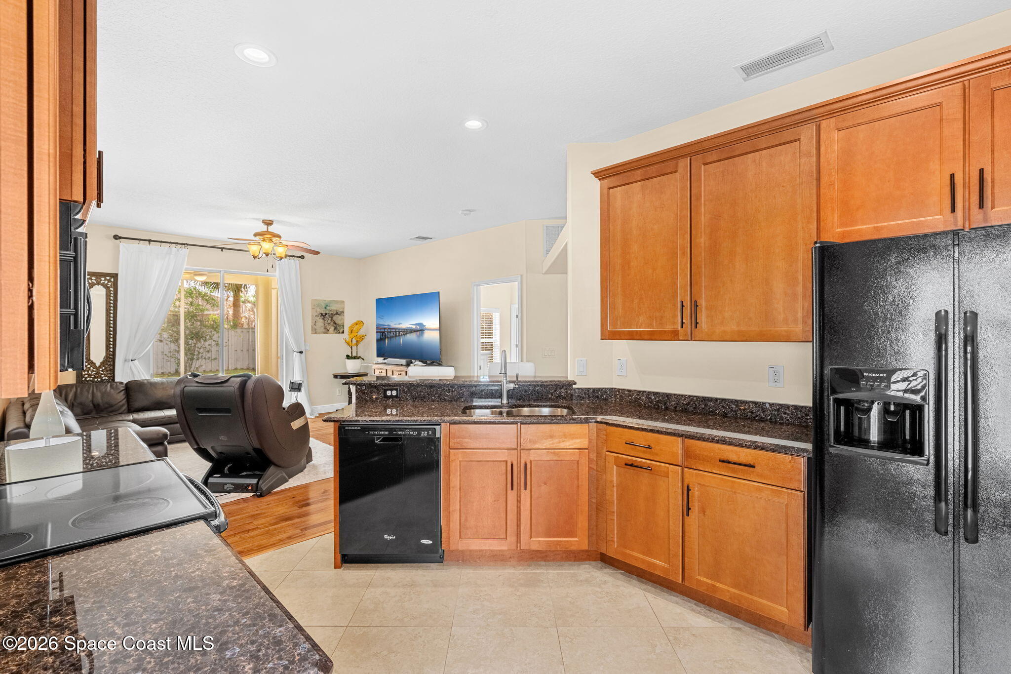 3751 Manitoba Way Rockledge, FL 32955 - Photo 10 of 64 a kitchen with stainless steel appliances granite countertop a stove sink and cabinets
