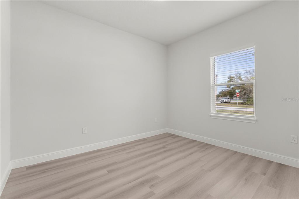 4016 Southwest 151st Street Ocala, FL 34473 - Photo 11 of 32 a view of an empty room with wooden floor and a window