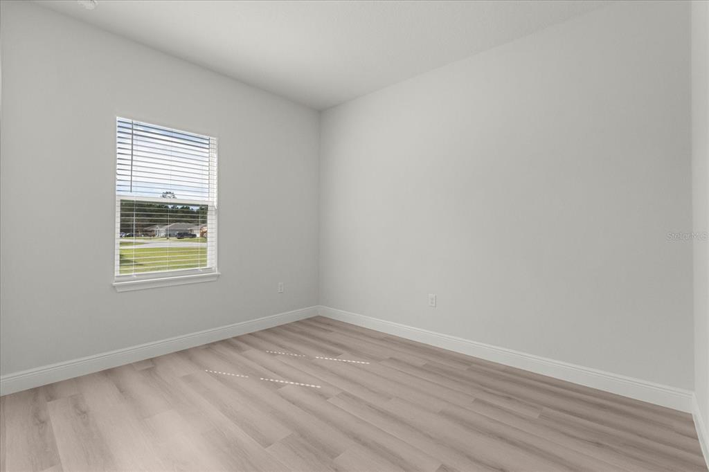 4016 Southwest 151st Street Ocala, FL 34473 - Photo 15 of 32 wooden floor in an empty room with a window