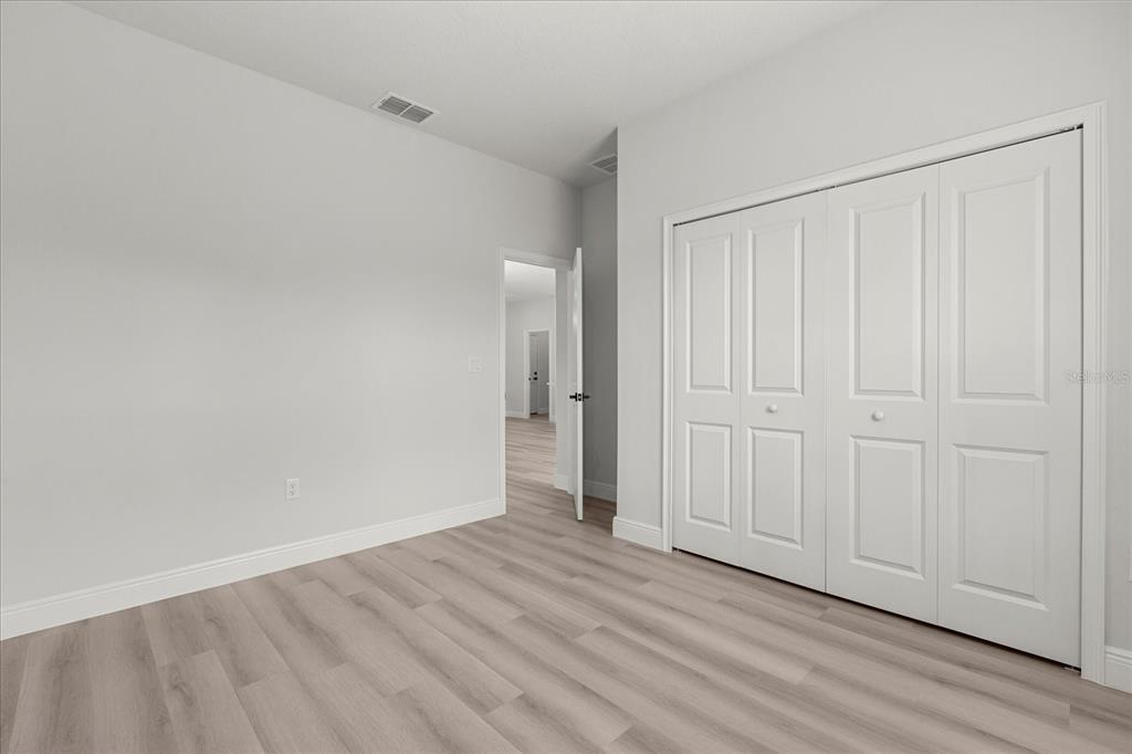 4016 Southwest 151st Street Ocala, FL 34473 - Photo 16 of 32 a view of an empty room with wooden floor