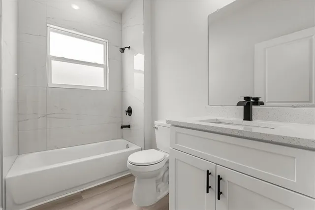 a bathroom with a sink a toilet and a bathtub