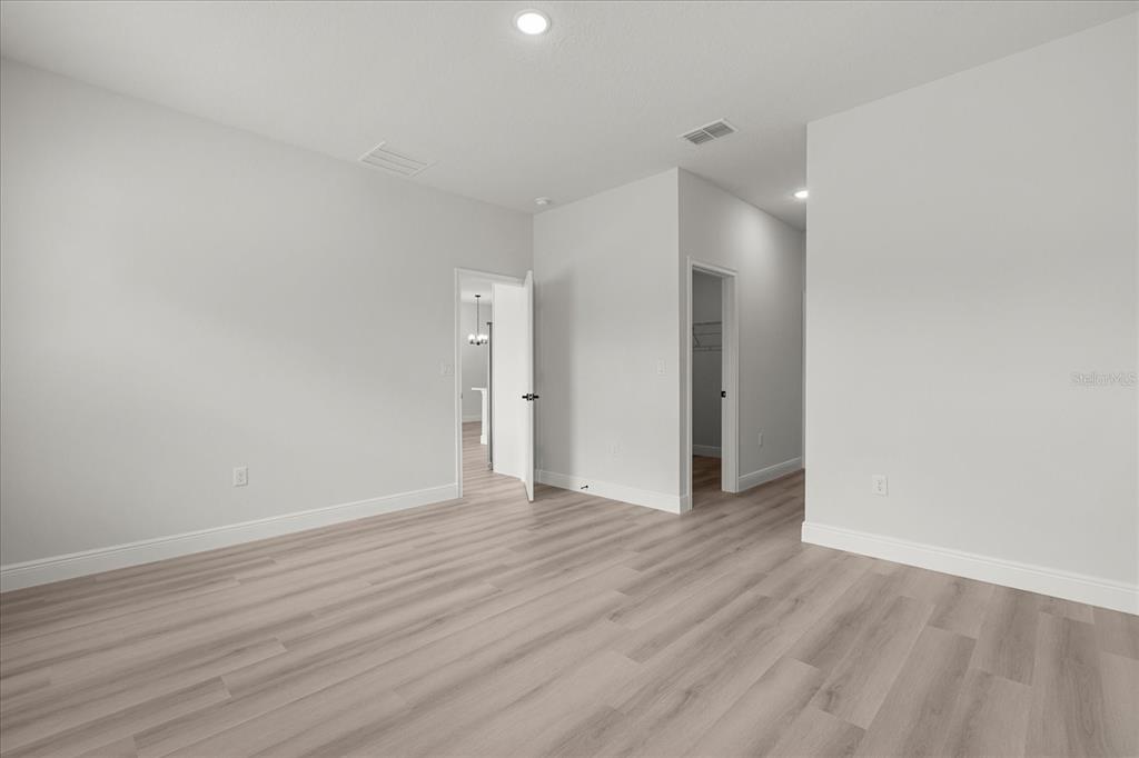 4016 Southwest 151st Street Ocala, FL 34473 - Photo 19 of 32 a view of an empty room with wooden floor