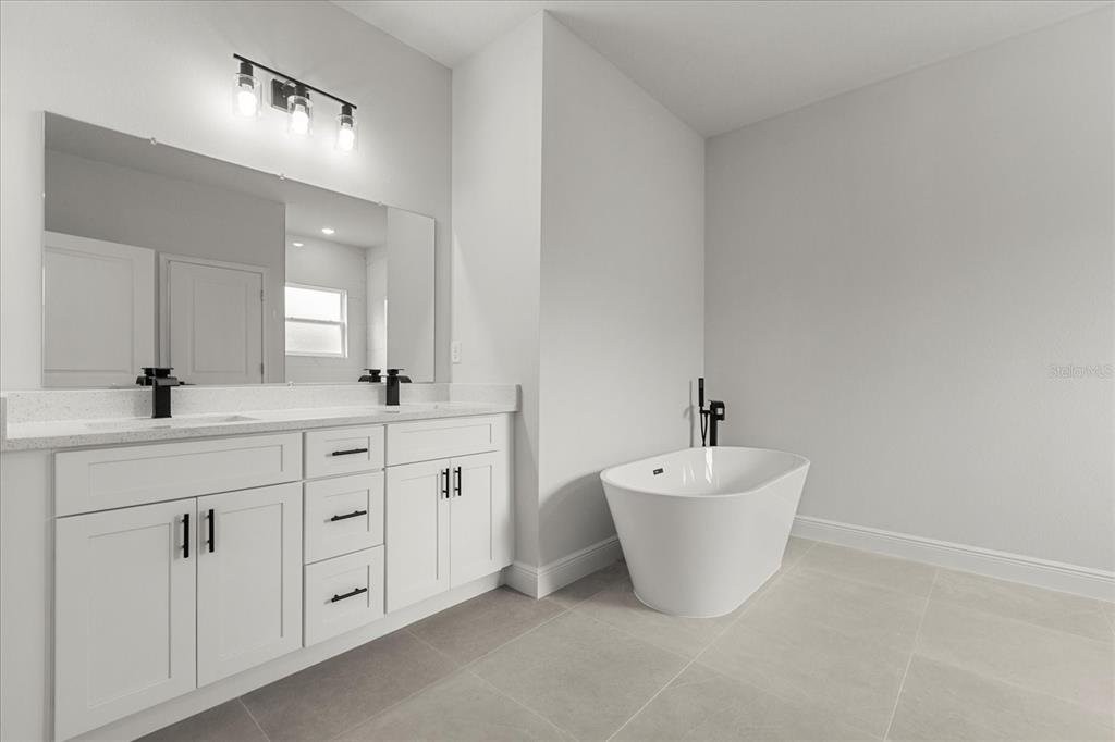 4016 Southwest 151st Street Ocala, FL 34473 - Photo 21 of 32 a bathroom with a double sink and a mirror