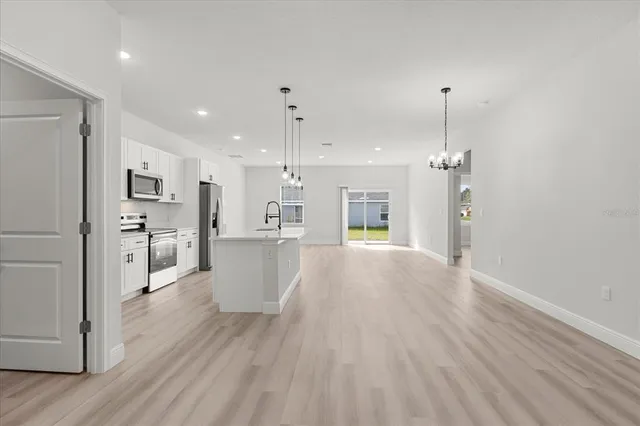 a view of a kitchen with wooden floor