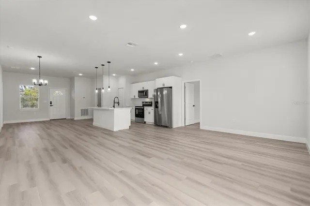 a view of a kitchen with a sink and a refrigerator