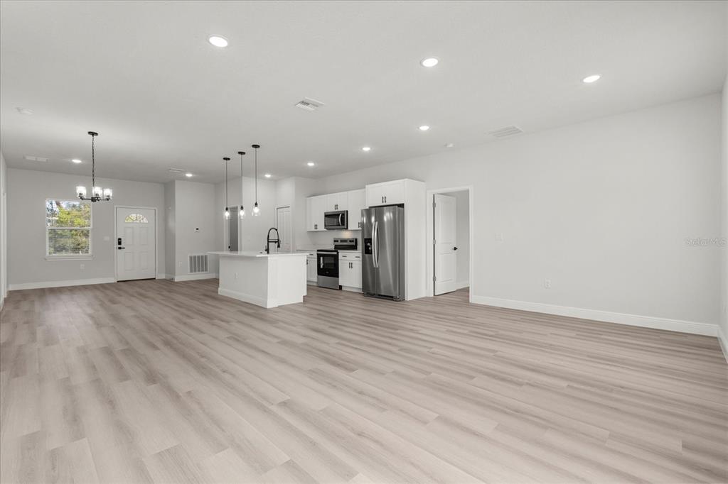 4016 Southwest 151st Street Ocala, FL 34473 - Photo 7 of 32 a view of a kitchen with a sink and a refrigerator