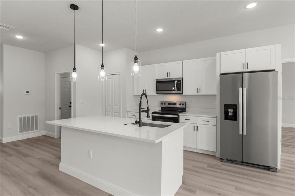 4016 Southwest 151st Street Ocala, FL 34473 - Photo 9 of 32 a kitchen with stainless steel appliances a refrigerator sink and microwave
