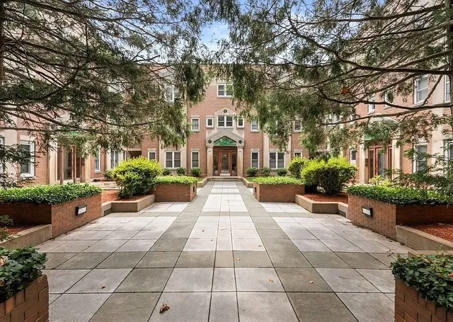 a front view of a building with garden