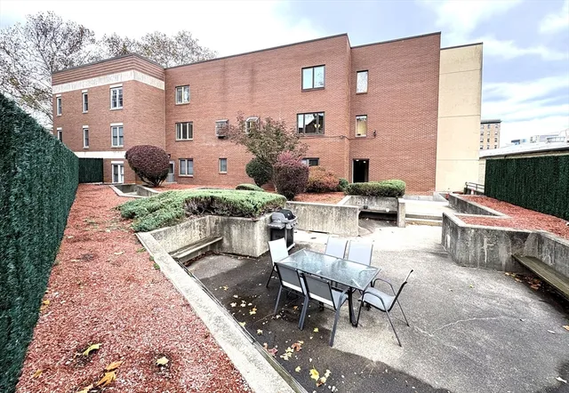 a view of a patio with furniture and a fire pit