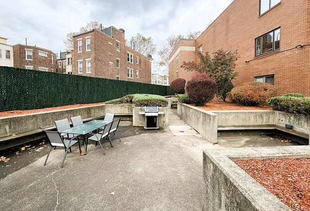 a view of a patio with table and chairs and potted plants