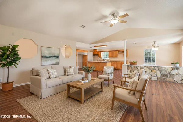 a living room with furniture and a chandelier