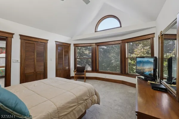a bedroom with a large bed and a large window