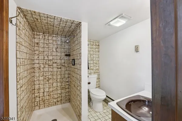 a bathroom with a toilet and a shower curtain