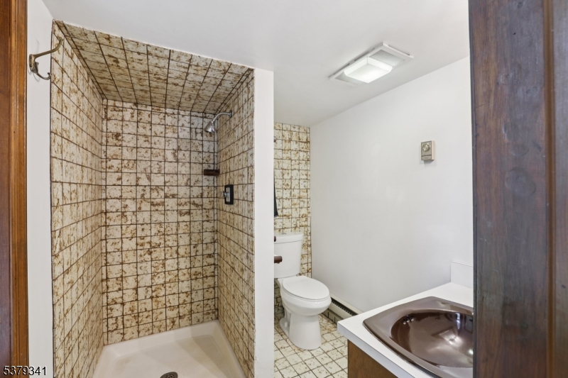 833 Berkshire Valley Road Wharton, NJ 07885 - Photo 18 of 48 a bathroom with a toilet and a shower curtain
