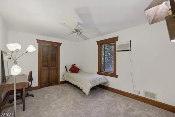 a bed room with a bed and a window