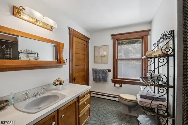 a bathroom with a toilet sink and mirror