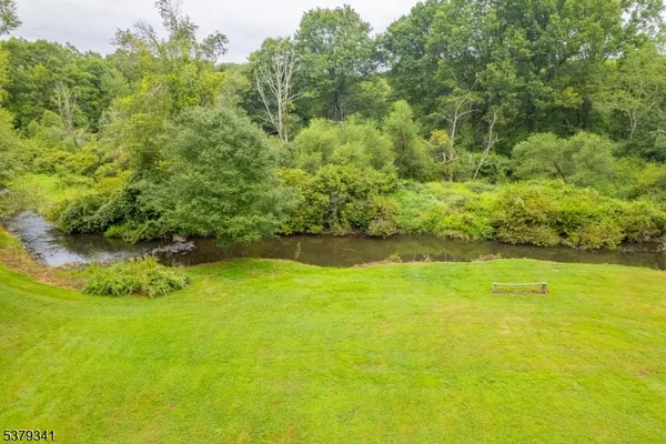 an aerial view of a house with a yard and lake view