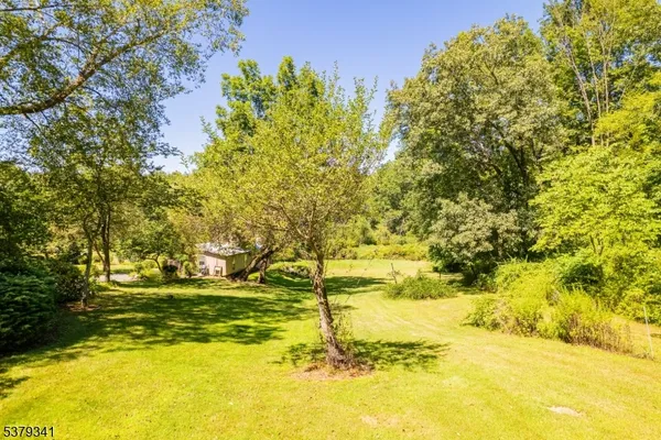 a backyard of a house with a yard and outdoor seating
