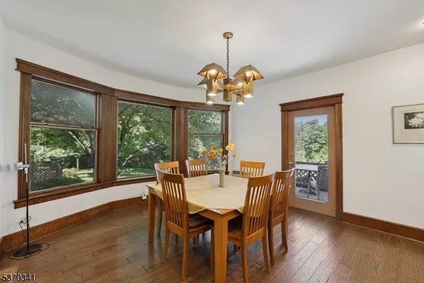 a view of a dining room with furniture wooden floor and chandelier