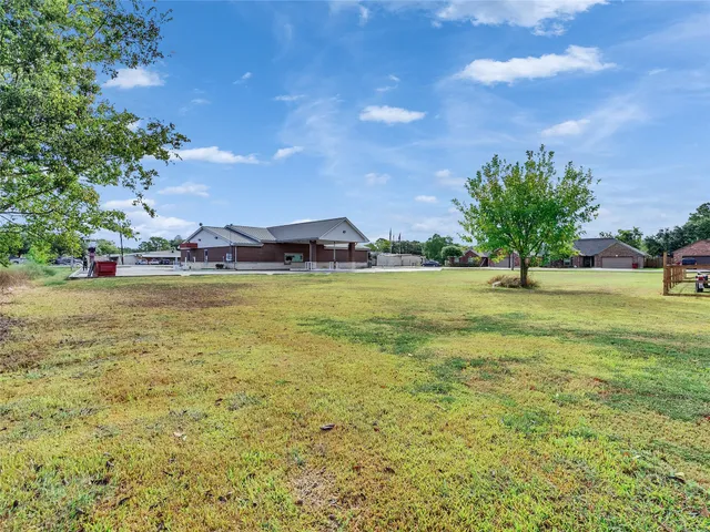 a view of yard with swimming pool and green space