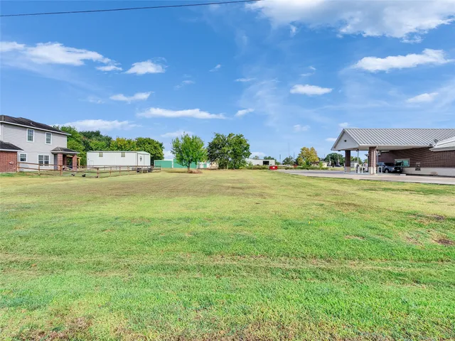 a view of a building with yard and lake view