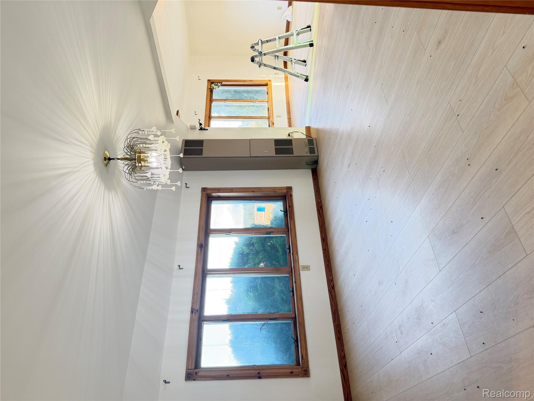 2455 Jacob Road Caro, MI 48723 - Photo 7 of 28 Unfurnished living room featuring hanging lights, light wood-style flooring, and a heating unit