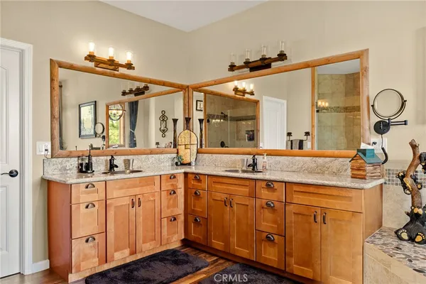 a spacious bathroom with a granite countertop sink a large mirror a vanity and a